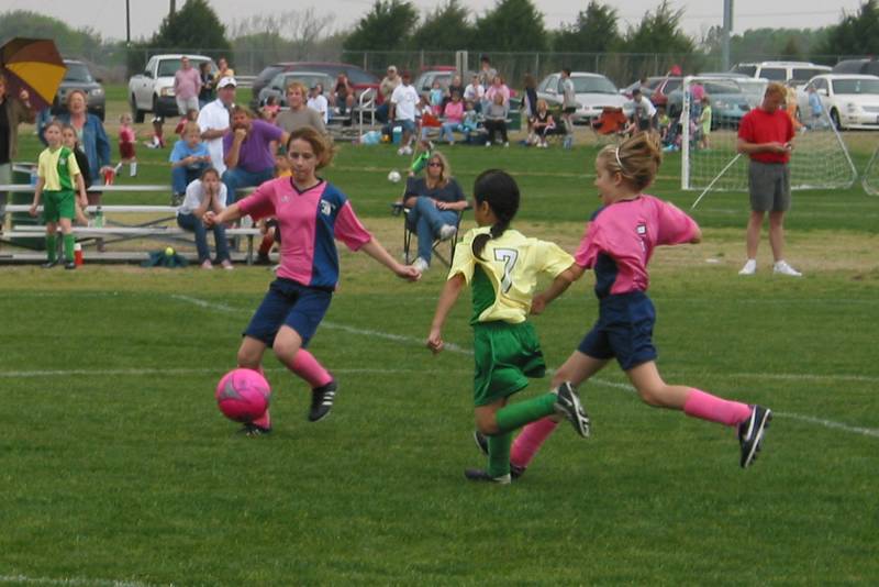 Holly handles the ball as Lulu rushes in to help