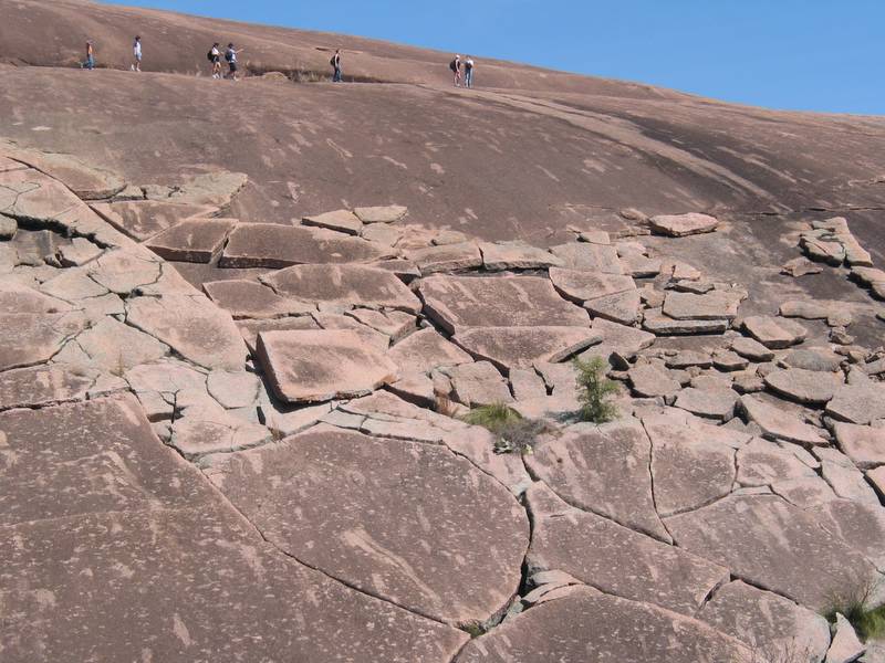Some people trying to find an easy way down from Enchanted Rock