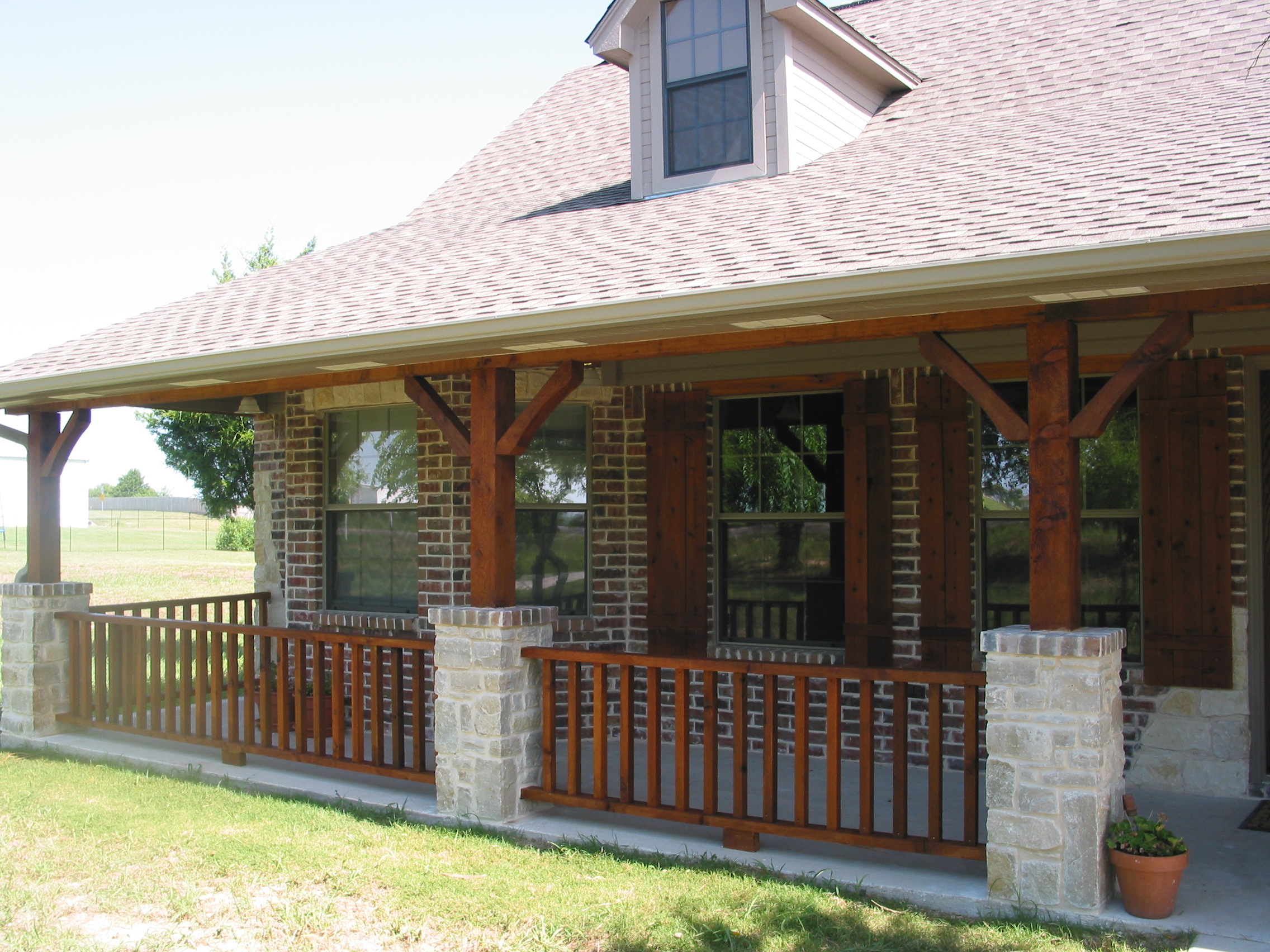 A close-up of the new columns and shutters after they were stained. The guttering has also been completed.