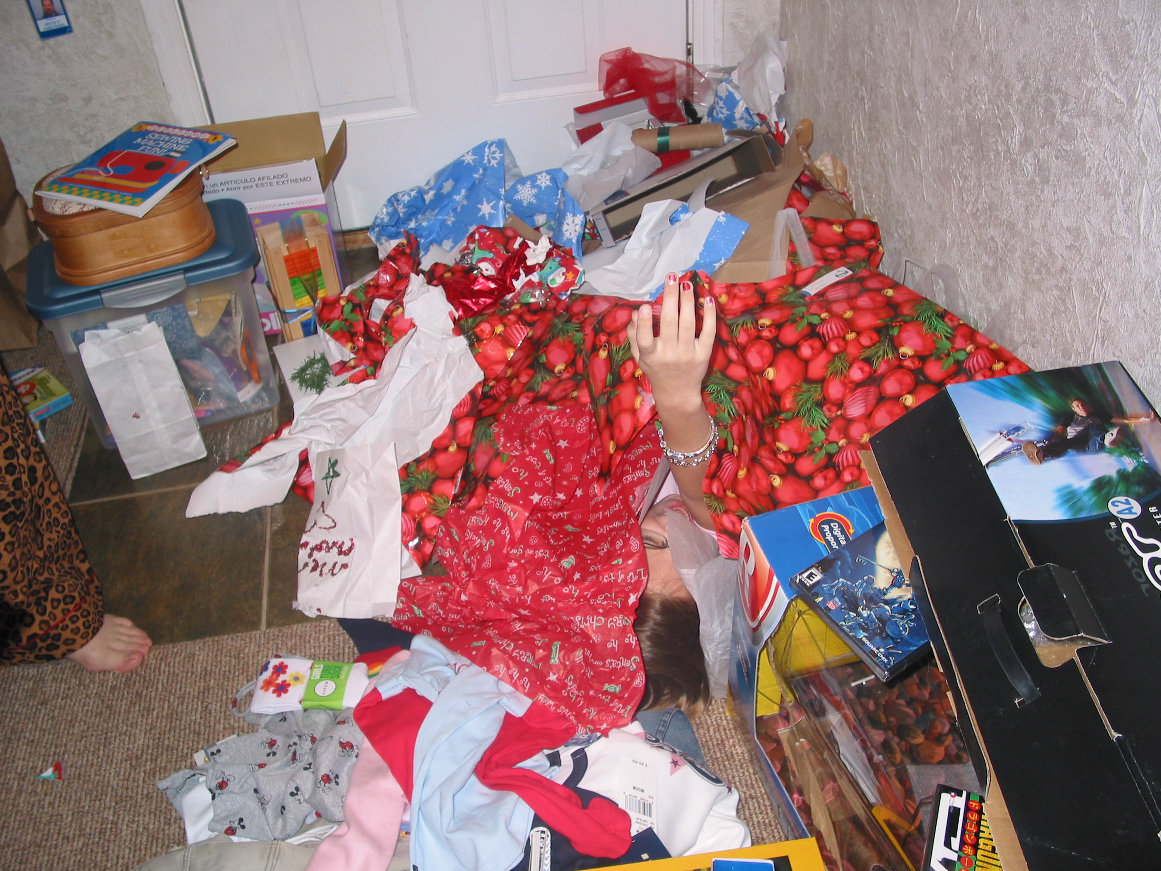 Holly, lost in the mountain of wrapping paper.