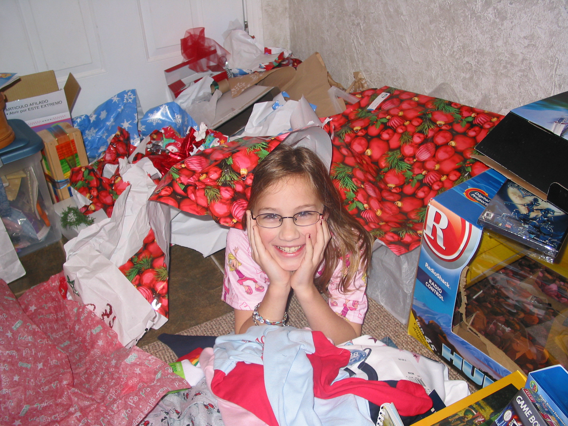 Holly emerges from the wrapping paper pile.