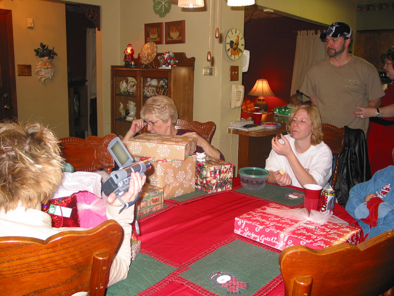 Loretta behind her stack of gifts.