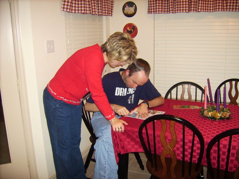 Michelle watches Chris scratch off