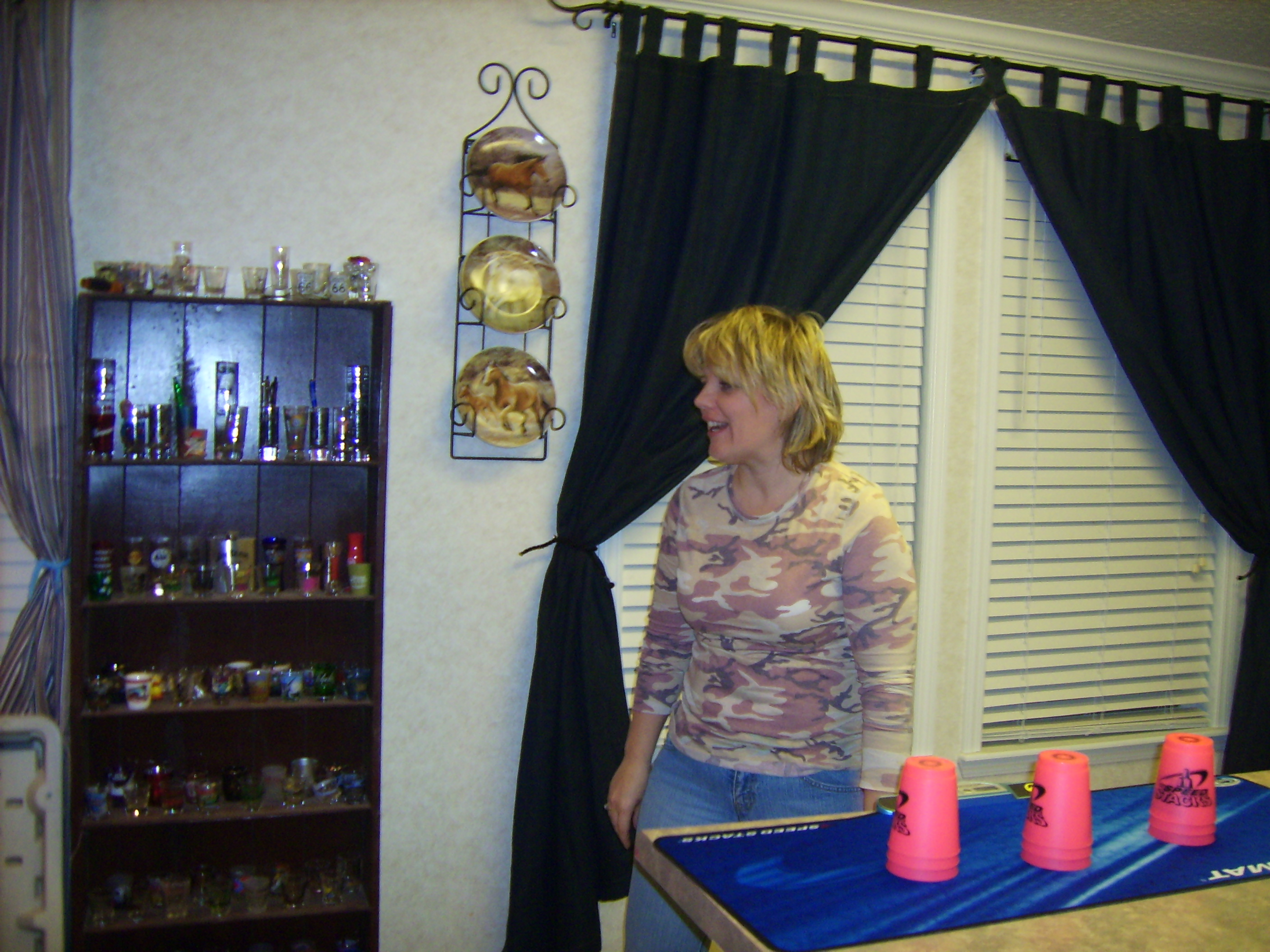 At least Chris can laugh at her lack of cup stacking skills