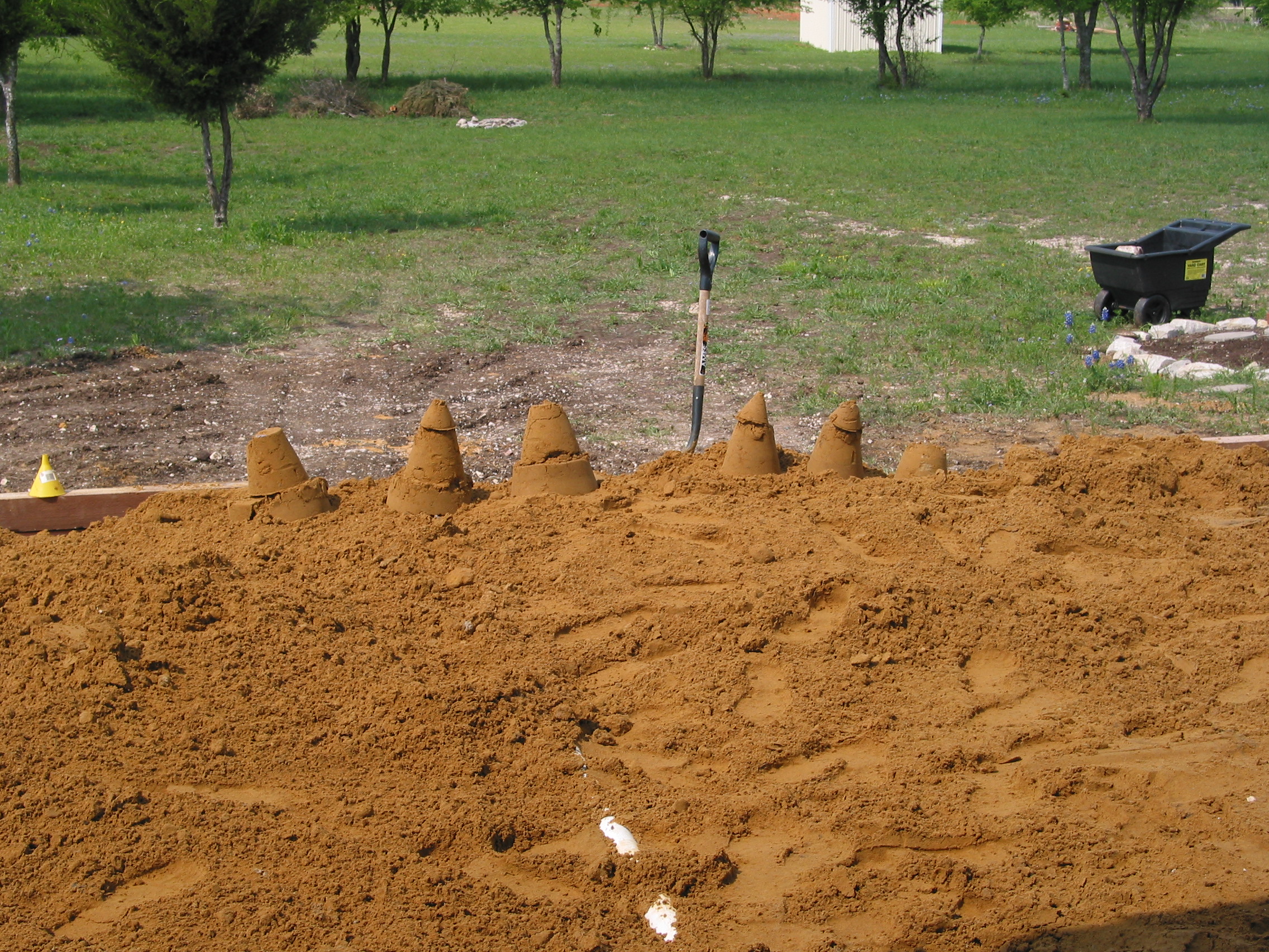 Bruce and Joe built some quick sand castles to make Michelle think they were goofing off instead of working.