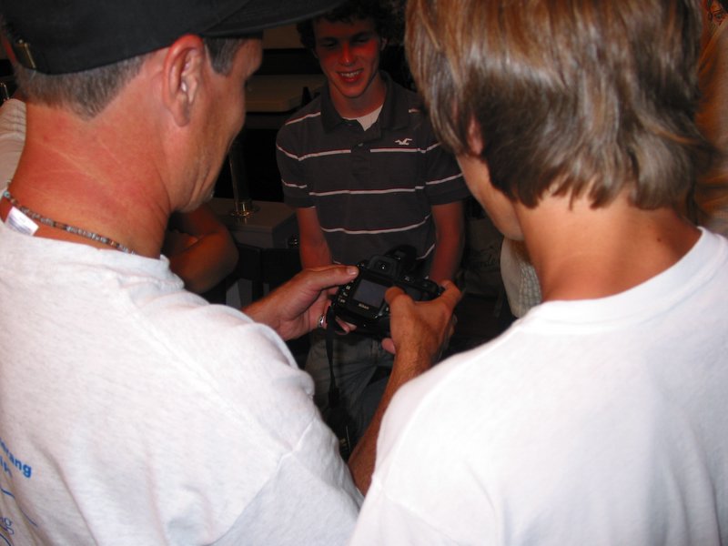 Gregg, Ace, and Logan look at some photos