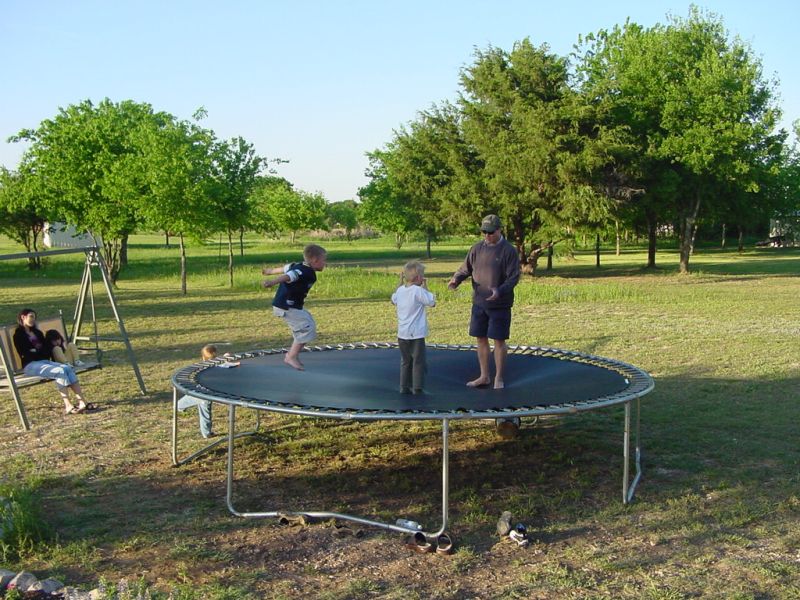 Ethan, Marcus, and Kevin on the trampoline.
